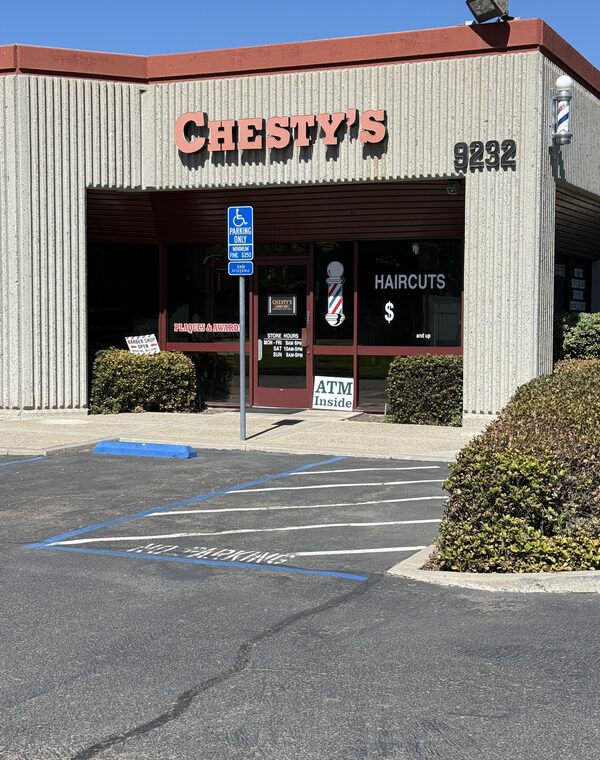 The CHESTY'S sign and the number 9232 above the storefront, seen from the parking lot